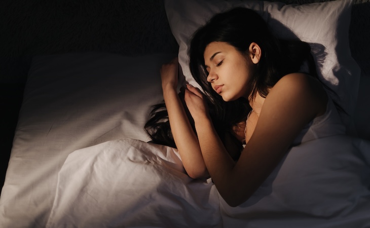Woman sleeping peacefully in bed