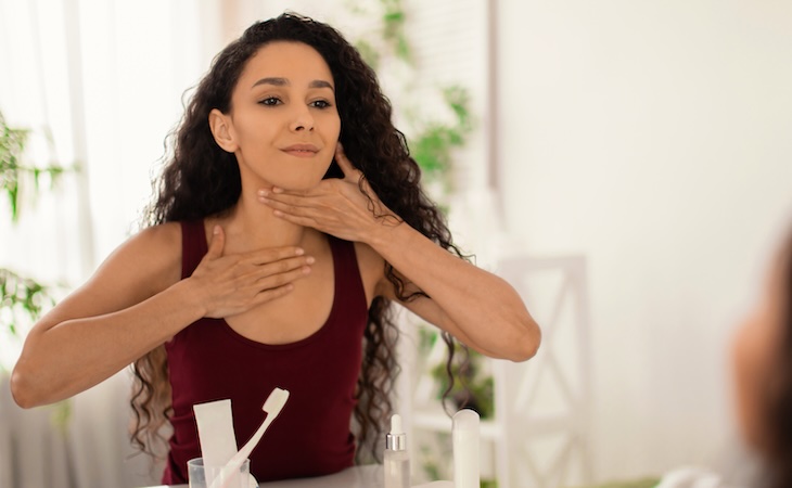 Woman performing lymphatic massage on herself