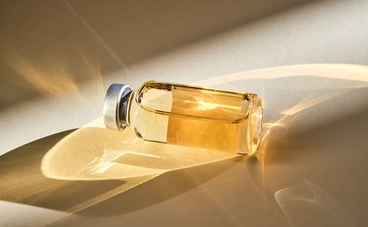 Glass vial with golden liquid inside - peptides
