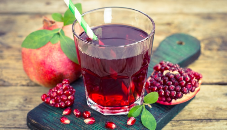 Glass of pomegranate juice with fruit